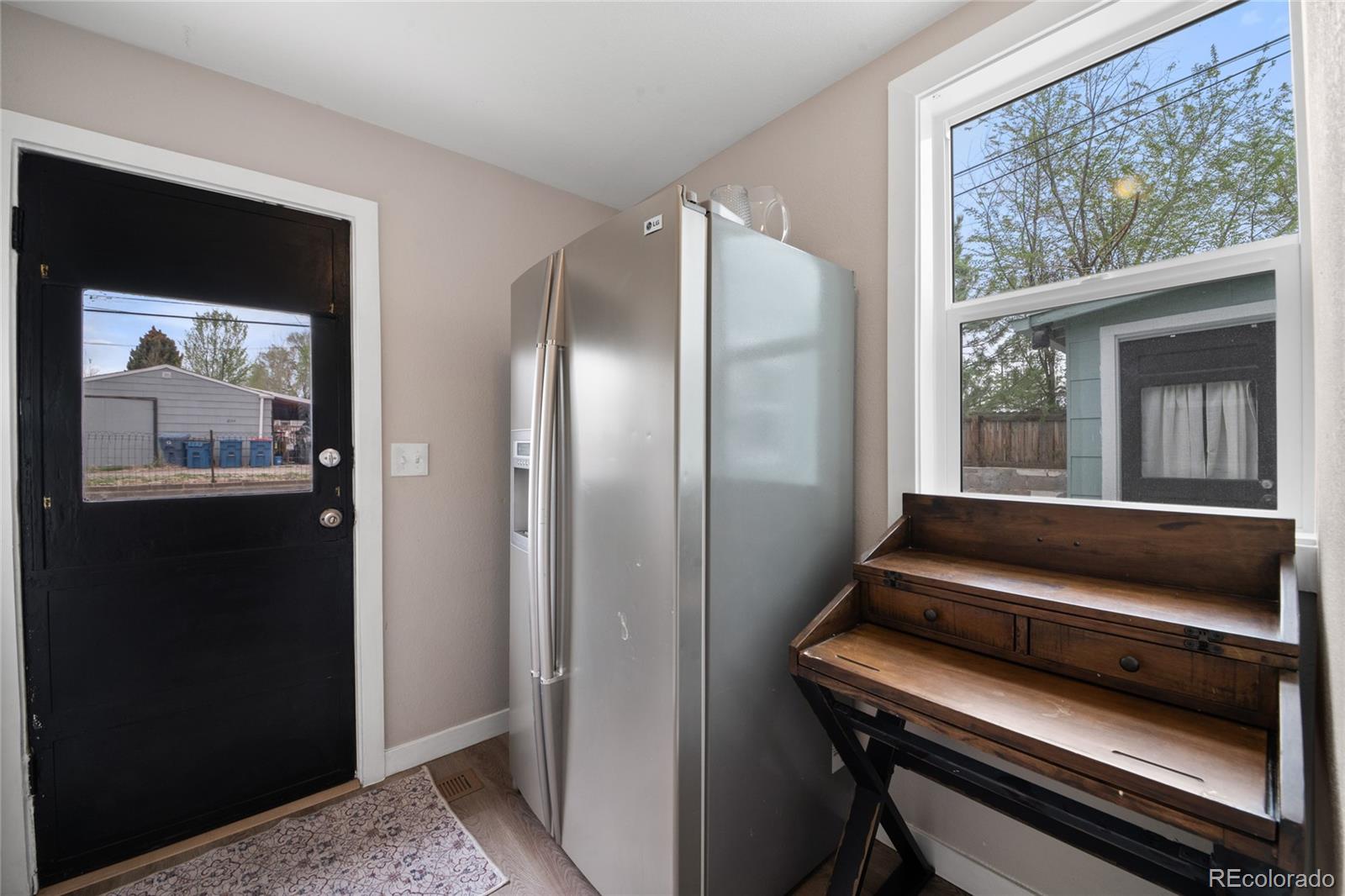 2045 Eaton Street Edgewater, CO 80214 - Photo 23 of 28 a view of kitchen with wooden floor and a large window