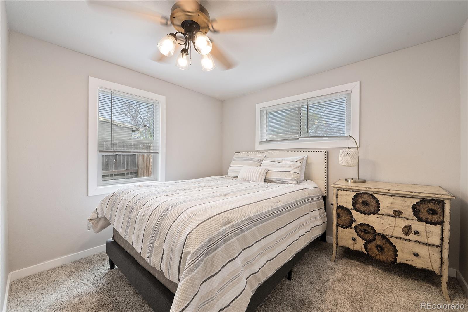 2045 Eaton Street Edgewater, CO 80214 - Photo 3 of 28 a bedroom with a bed and a window