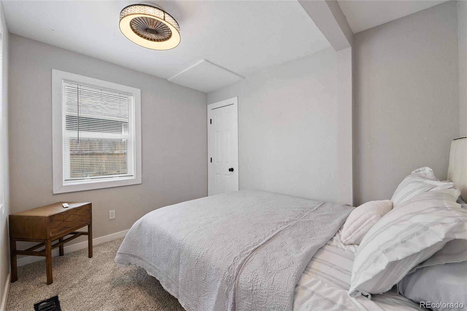 2045 Eaton Street Edgewater, CO 80214 - Photo 4 of 28 a bedroom with a bed and a window