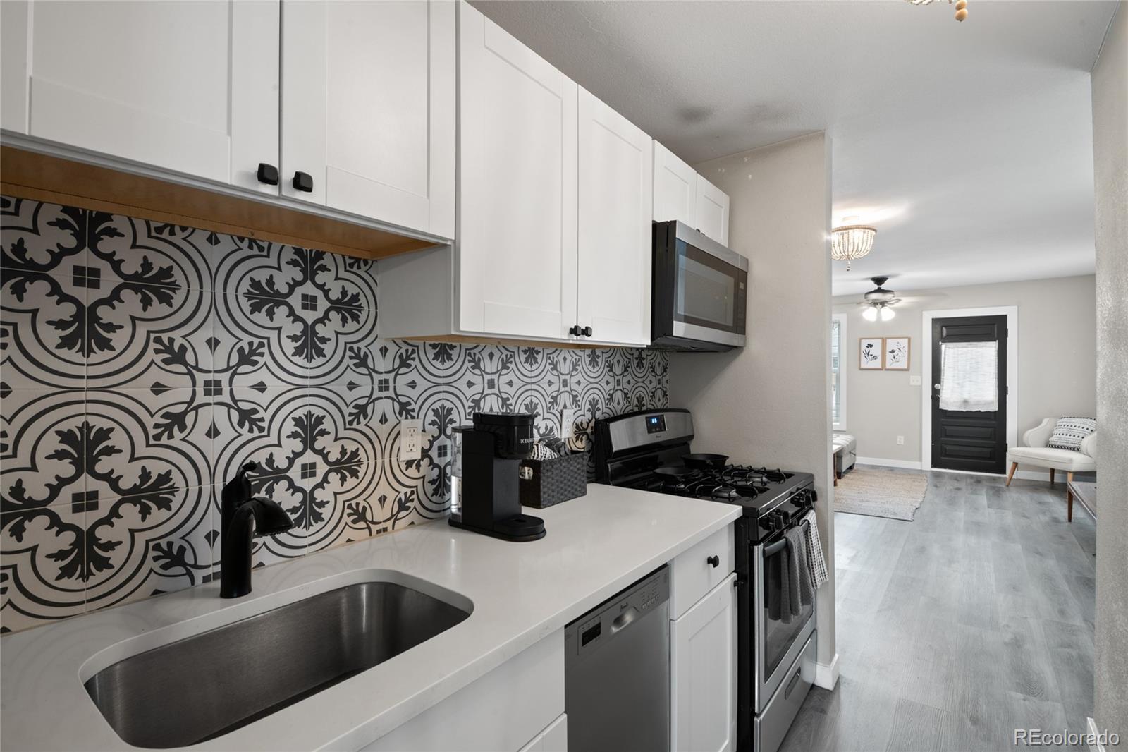 2045 Eaton Street Edgewater, CO 80214 - Photo 5 of 28 a kitchen with a sink a stove and cabinets