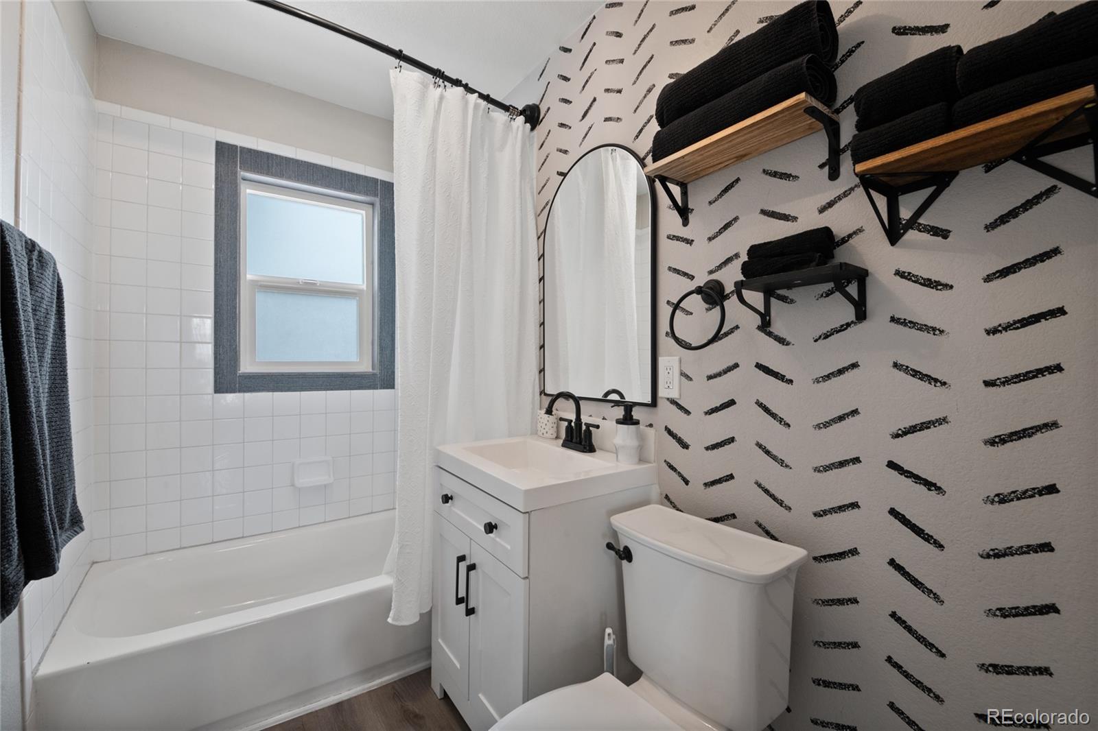 2045 Eaton Street Edgewater, CO 80214 - Photo 8 of 28 a bathroom with a sink toilet vanity and shower