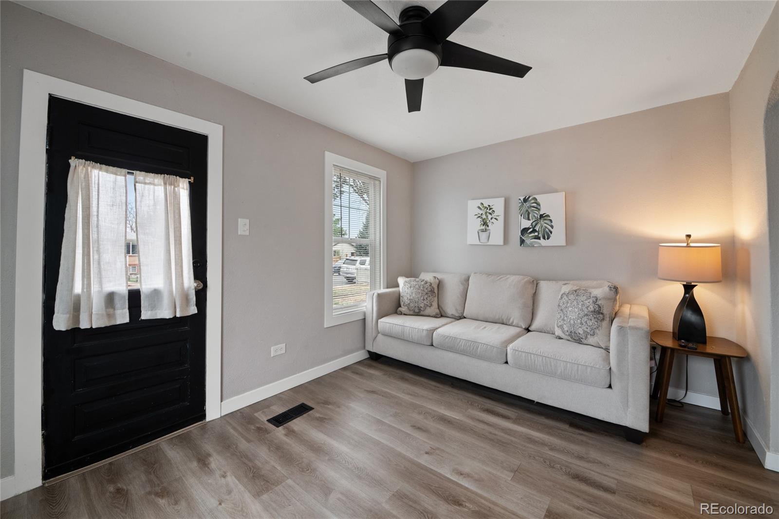 2045 Eaton Street Edgewater, CO 80214 - Photo 9 of 28 a living room with furniture and a lamp