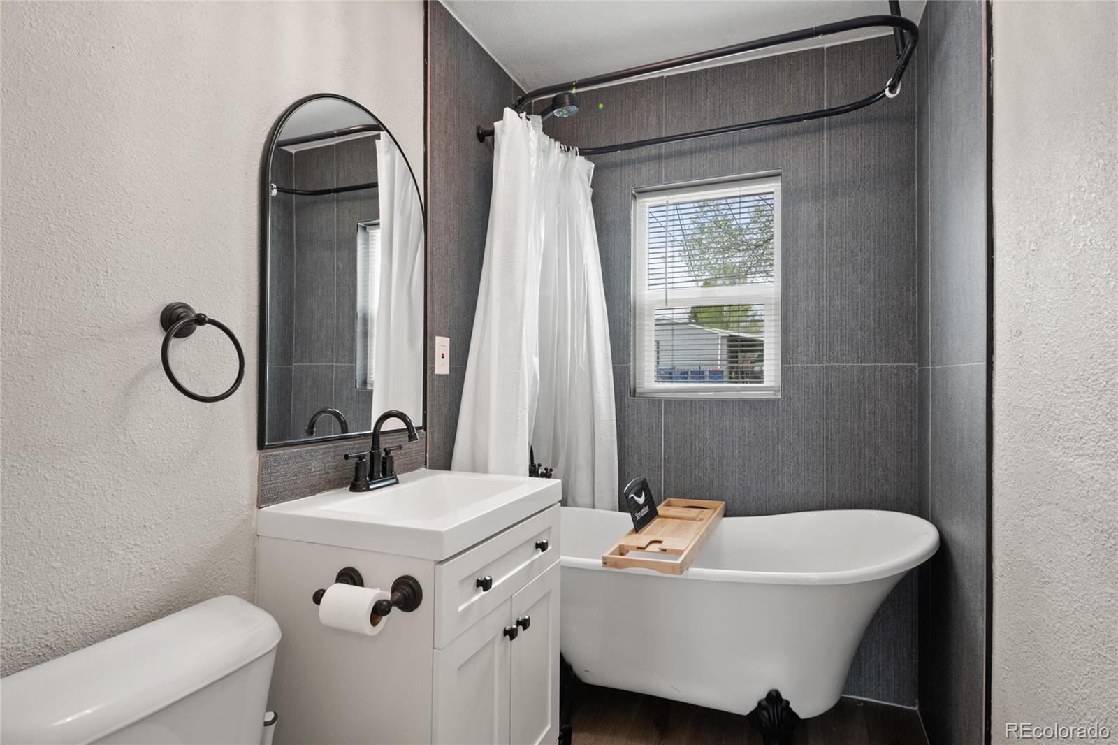 2045 Eaton Street Edgewater, CO 80214 - Photo 10 of 28 a bathroom with a sink mirror and toilet