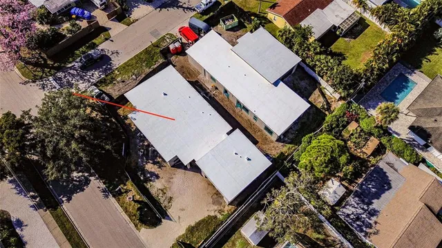an aerial view of a house with a yard