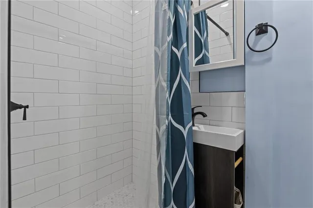 a bathroom with a shower toilet and sink