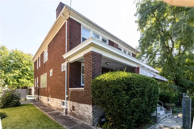 a view of an empty room with a window and fireplace