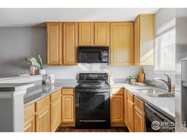 a kitchen with a stove a sink and a microwave