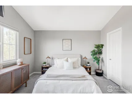 a bedroom with a bed and a potted plant