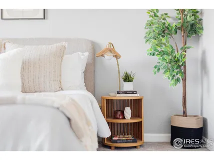 a bed room with a bed and a potted plant