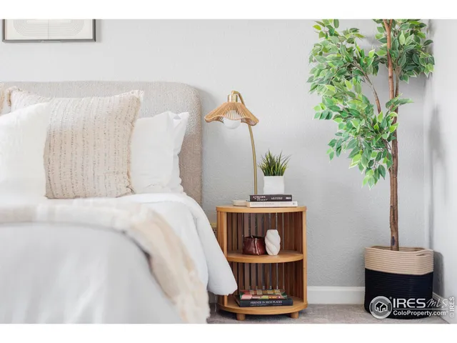 a bed room with a bed and a potted plant
