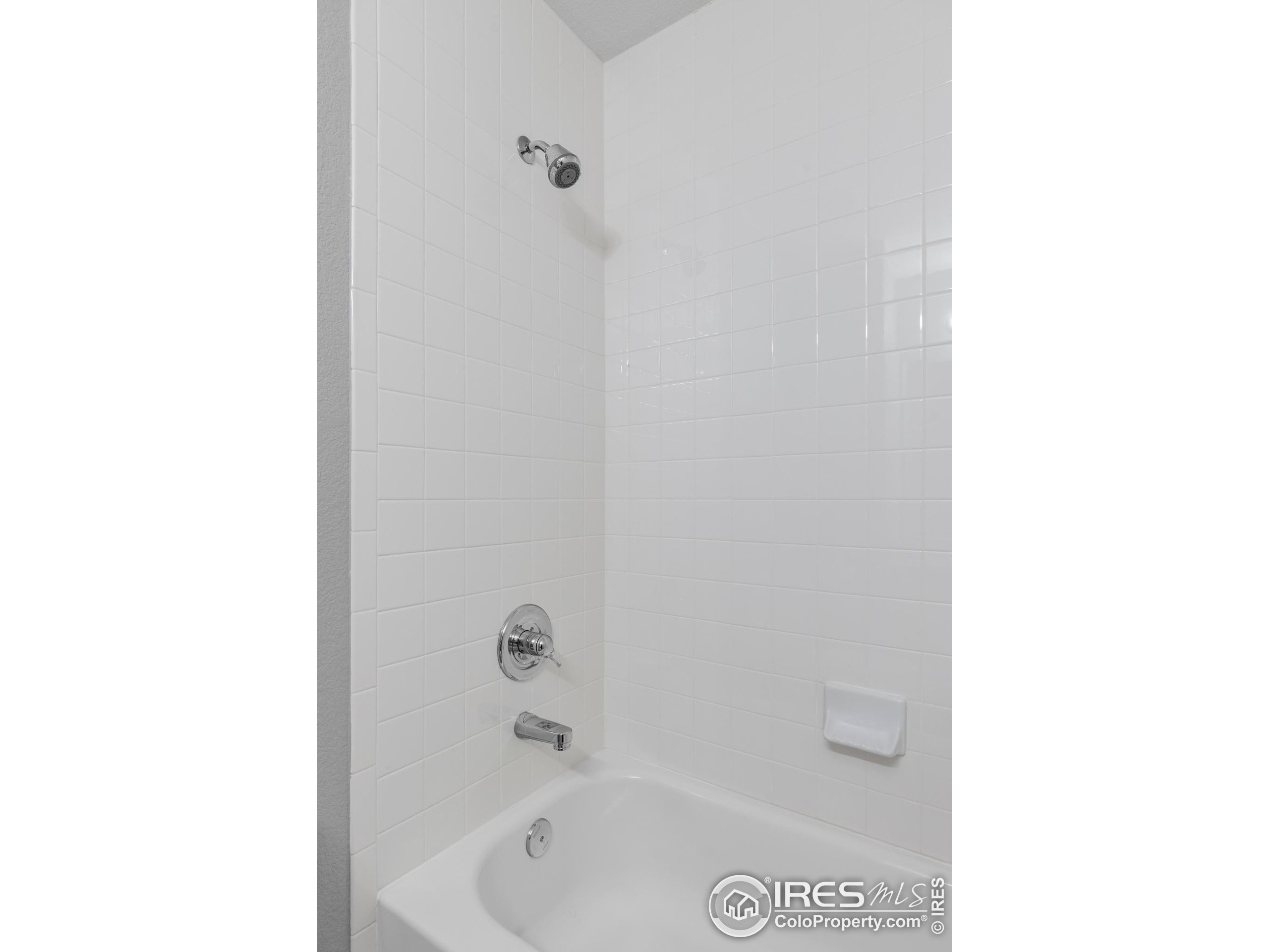 4240 Riley Drive Longmont, CO 80503 - Photo 24 of 25 a bath tub sitting next to a white sink