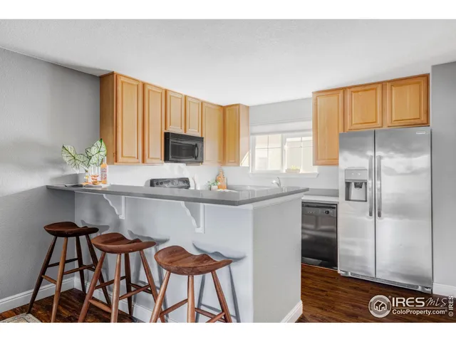 a kitchen with kitchen island a counter top space cabinets and stainless steel appliances