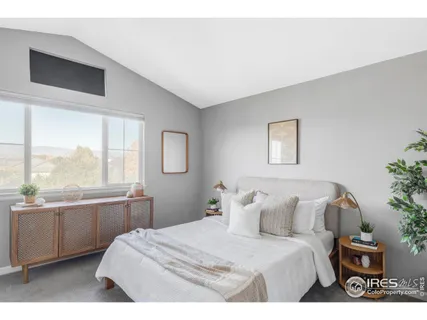 a bedroom with a large bed and a large window