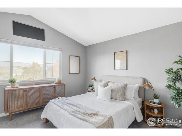 a bedroom with a large bed and a large window