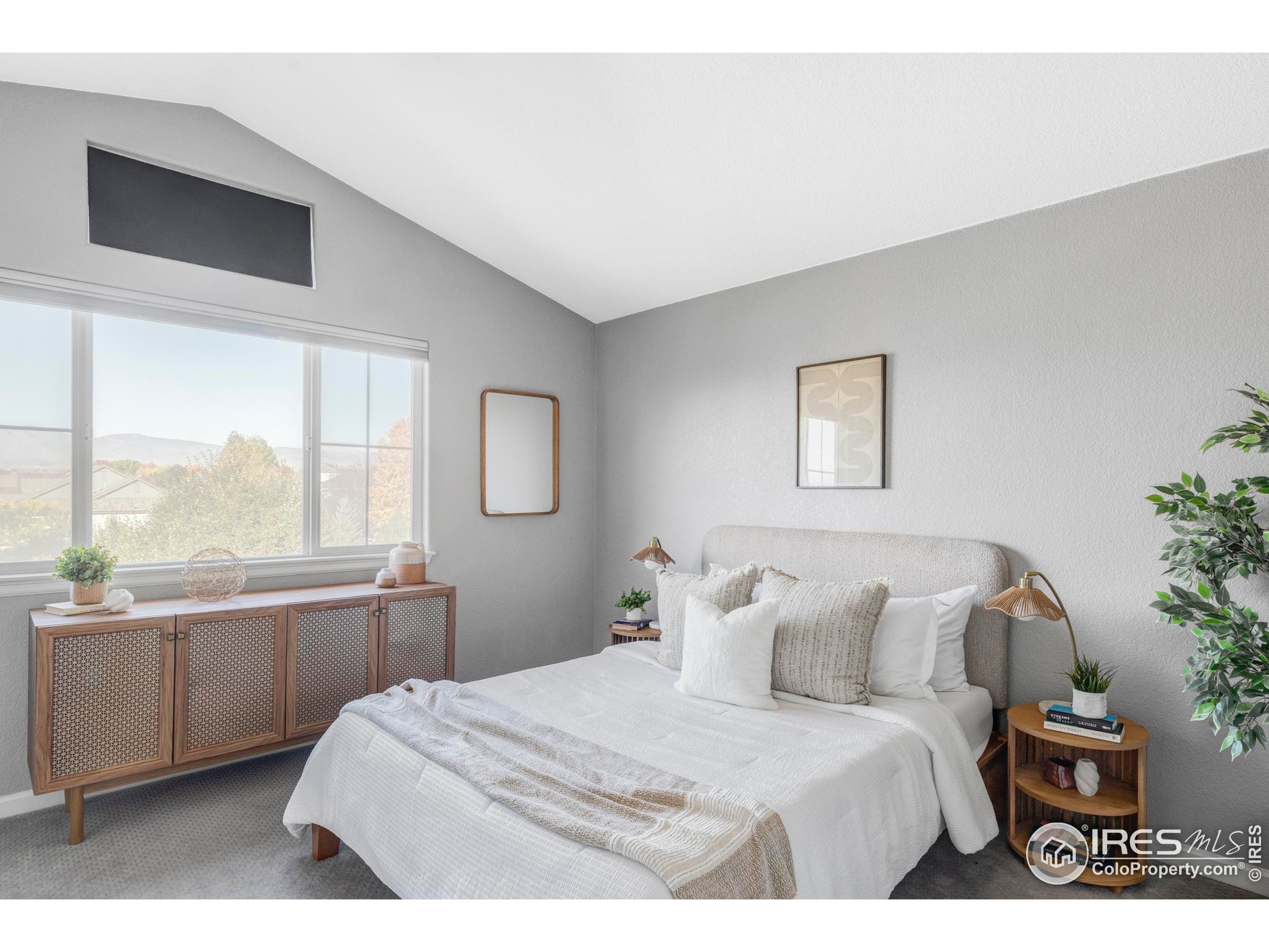 4240 Riley Drive Longmont, CO 80503 - Photo 4 of 25 a bedroom with a large bed and a large window