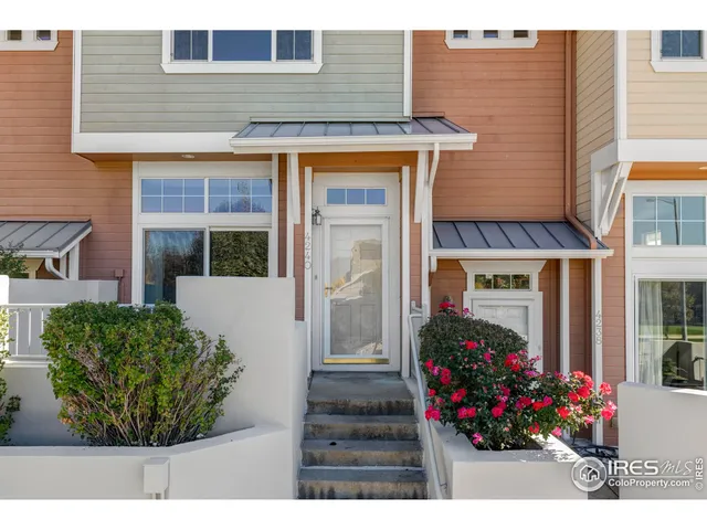 a view of a house with potted plants