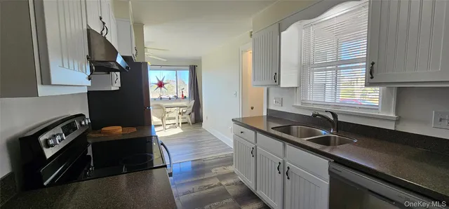 a kitchen that has a sink and cabinets