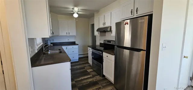 a kitchen with a refrigerator a stove and a sink