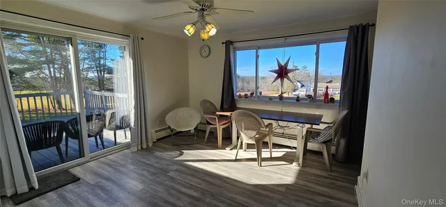 a dining room with wooden floor a chandelier a wooden table and chairs