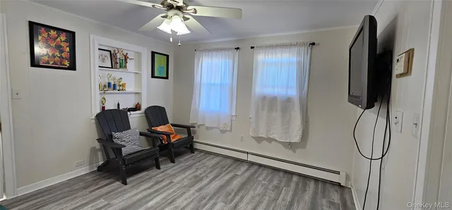 a view of a workspace with furniture and chandelier fan