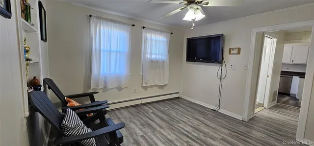 a room with wooden floor and windows