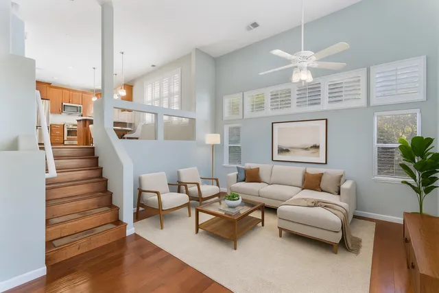 a living room with furniture wooden floor and a chandelier