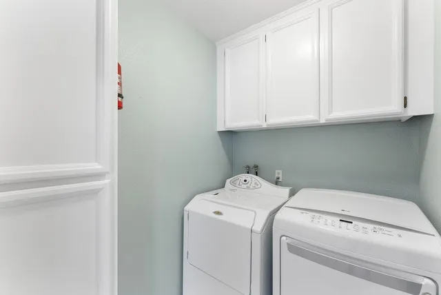 a view of storage and utility room with washer and dryer