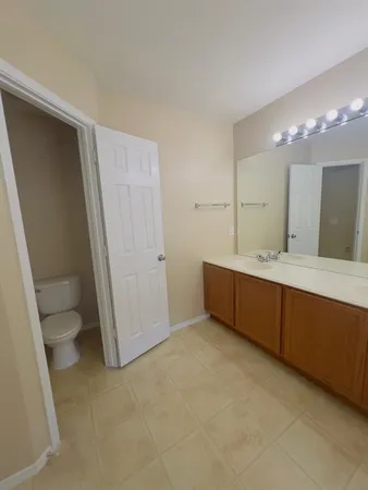 a bathroom with a double vanity sink toilet and shower