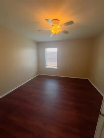 a view of room with window and hardwood floor