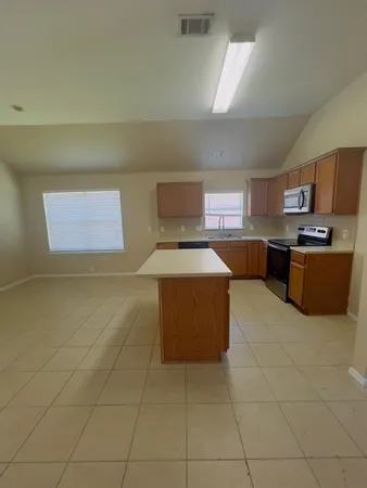 a kitchen with a cabinets and window