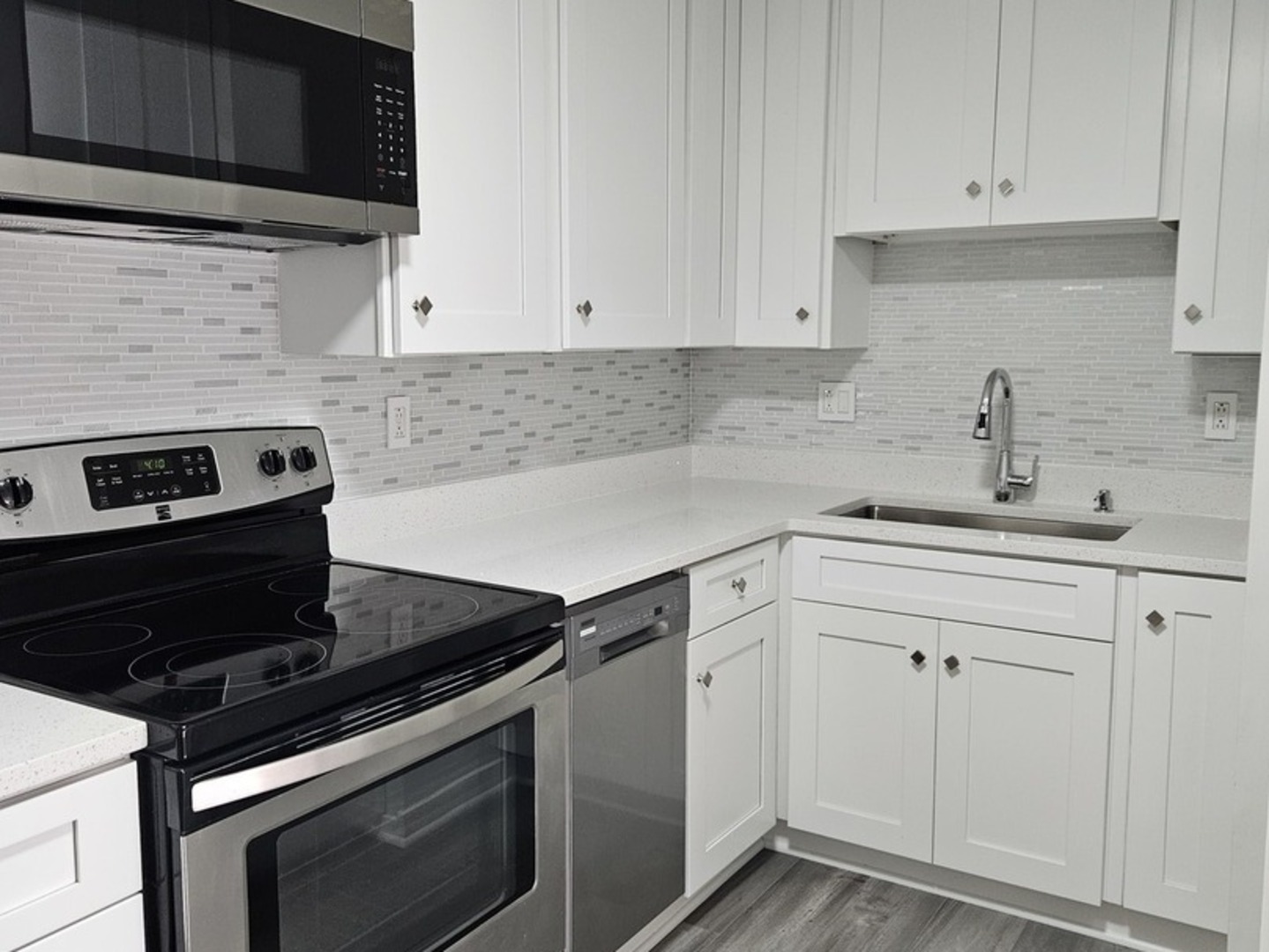 701 West Central Road, Unit B3 Mount Prospect, IL 60056 - Photo 8 of 19 a kitchen with white cabinets and black appliances