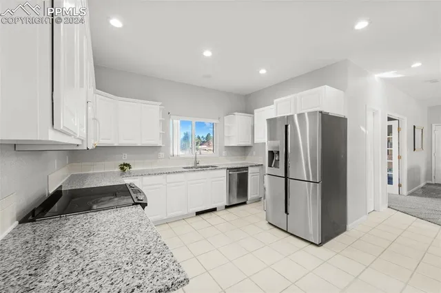a kitchen with a refrigerator and a sink
