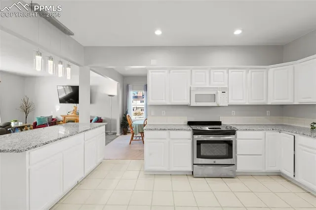 a kitchen with cabinets and white appliances