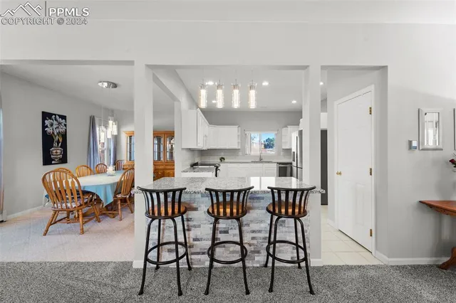 a dining room with furniture and window