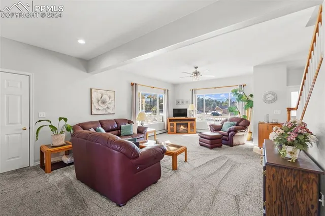 a living room with furniture and a potted plant