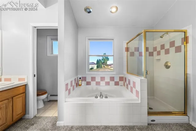 a bathroom with a tub a sink and mirror