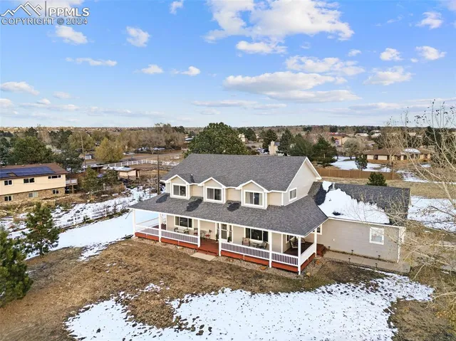an aerial view of a house with a ocean view