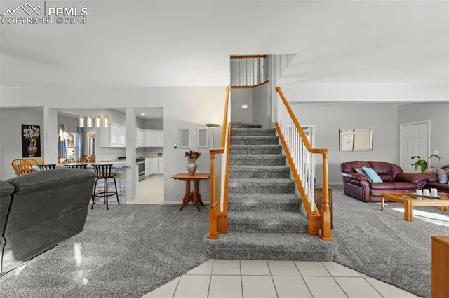 a living room with furniture and a dining table with wooden floor