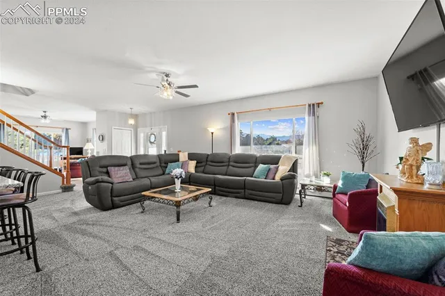 a living room with furniture a rug and a flat screen tv