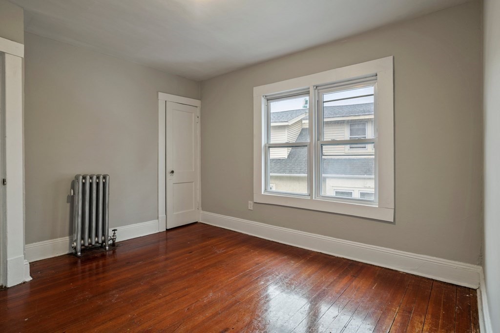 121-123 Orange Street Springfield, MA 01108 - Photo 8 of 32 an empty room with wooden floor and windows