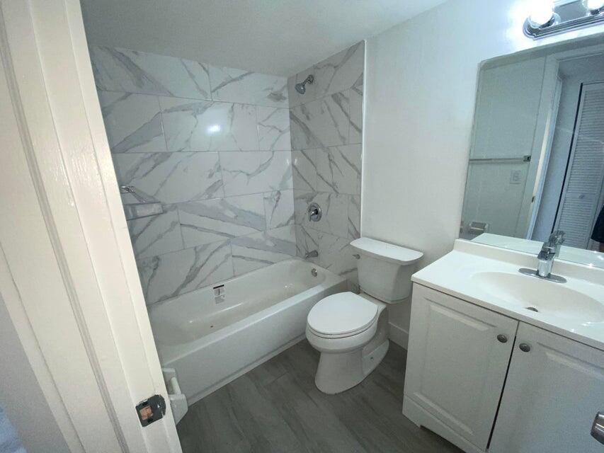 600 Southwest 2nd Avenue, Unit 140 Boca Raton, FL 33432 - Photo 12 of 30 a bathroom with a sink toilet and shower