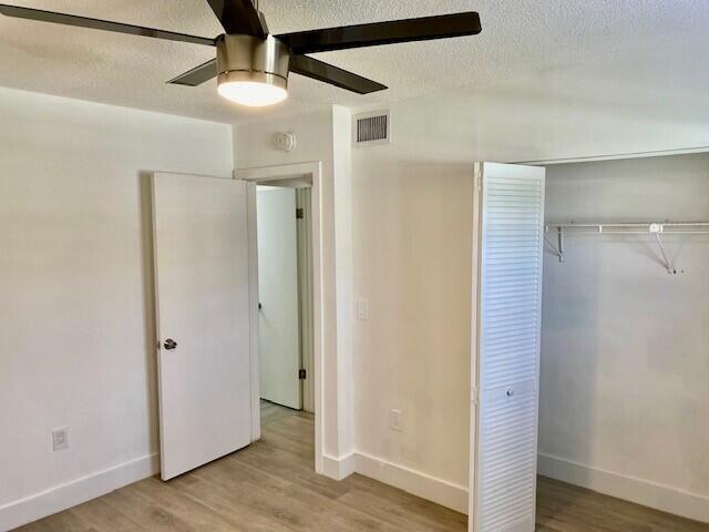 600 Southwest 2nd Avenue, Unit 140 Boca Raton, FL 33432 - Photo 5 of 30 a view of a hallway with wooden floor and staircase