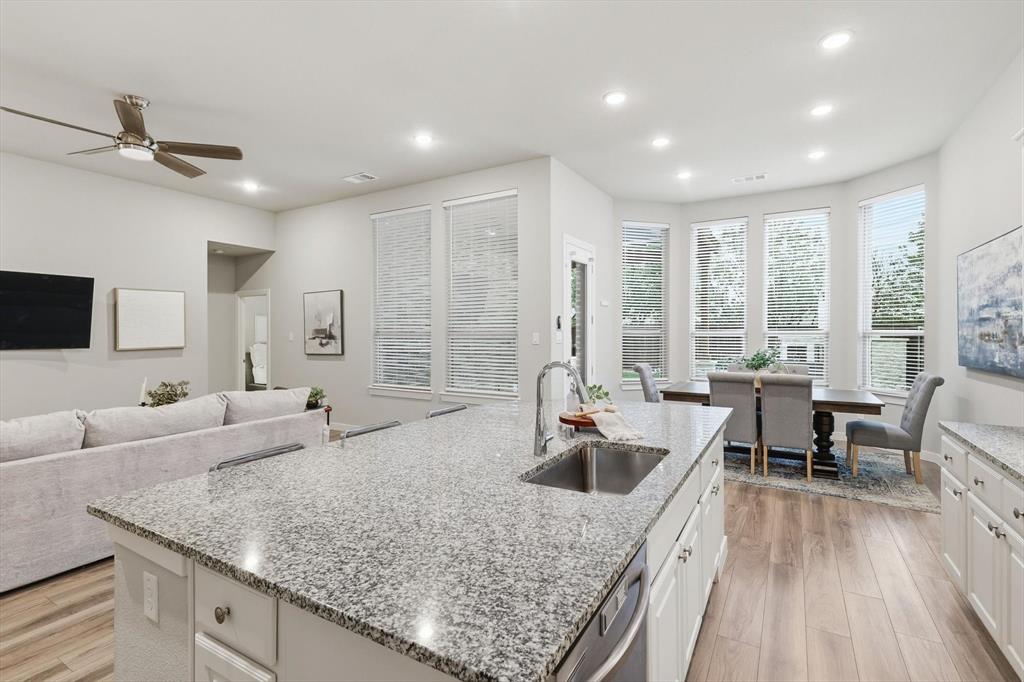 2912 Winding Ridge Court Little Elm, TX 75068 - Photo 16 of 40 Modern Open Concept kitchen with white cabinetry, gas cooktop, ss appliances, farm sink and plenty of storage!