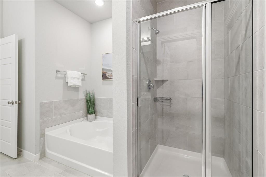 2912 Winding Ridge Court Little Elm, TX 75068 - Photo 25 of 40 Large ensuite bathroom with dual sinks, large soaking tub, walk in shower and large closet! Tons of natural light and modern finishes!