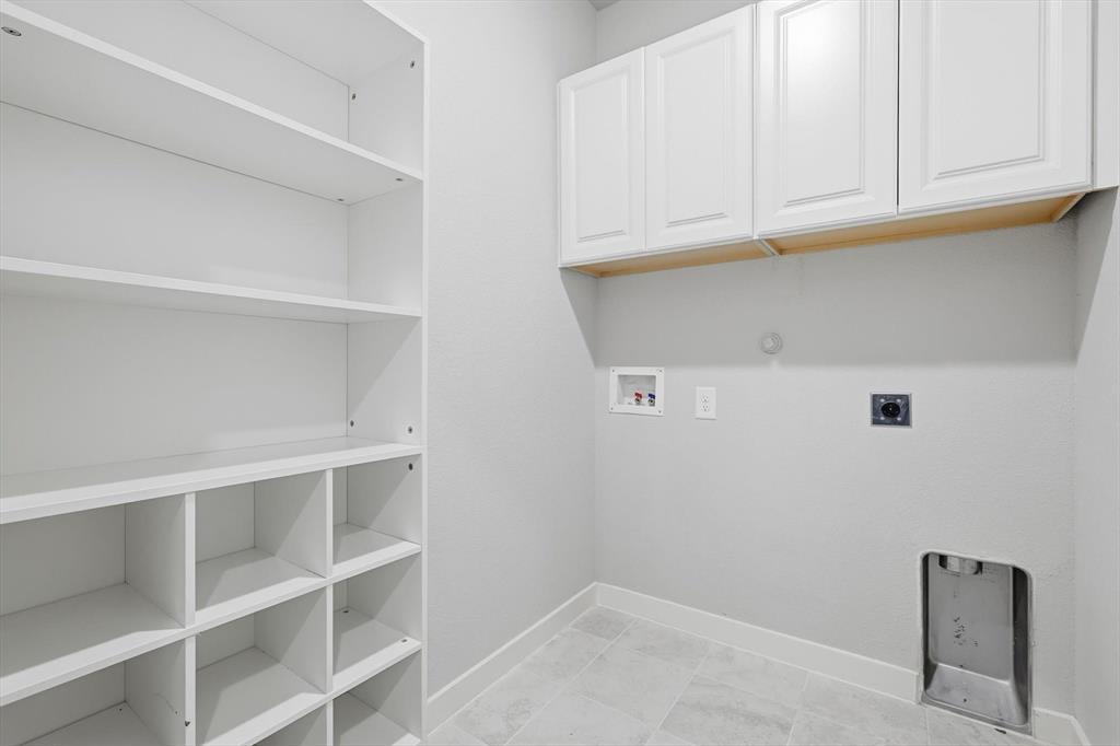 2912 Winding Ridge Court Little Elm, TX 75068 - Photo 33 of 40 Laundry room with ceramic tile floor, full size washer and dryer hookup and built in cabinets and additional storage.