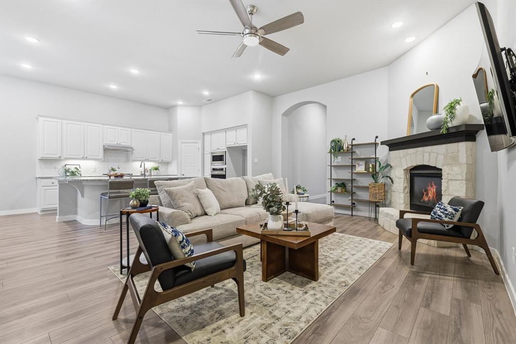 2912 Winding Ridge Court Little Elm, TX 75068 - Photo 8 of 40 Gorgeous open concept living room with built in shelving/storage, gas fireplace, LVP Flooring, Natural light the illuminates this area with an open space to dining and kitchen.