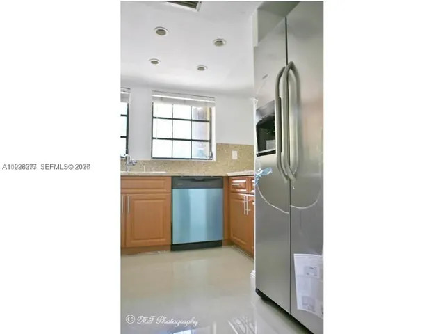 a bedroom with a bed and cabinets