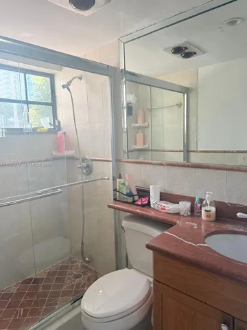 a view of a hallway with wooden floor and windows