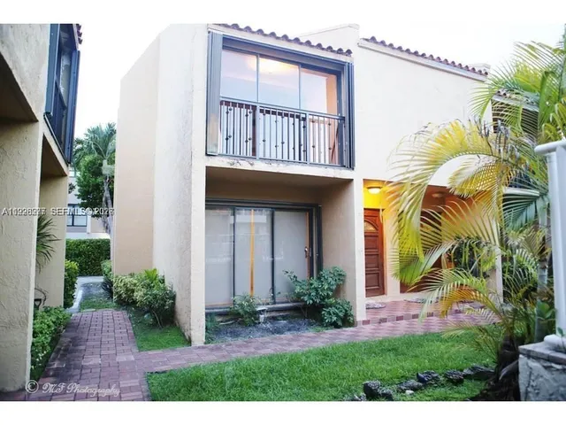 a view of a house with a yard and plants