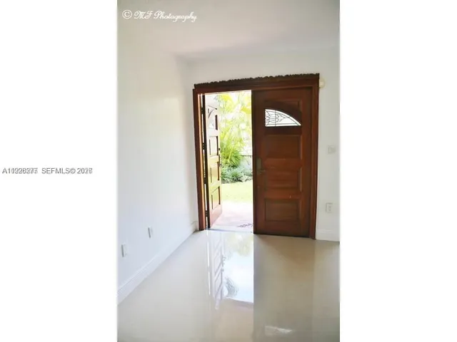 a view of a house with wooden floor and a outdoor space